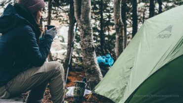 photo of woman and a tent with the caption: 6 reasons to go camping in the spring.