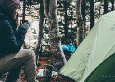 photo of woman and a tent with the caption: 6 reasons to go camping in the spring.