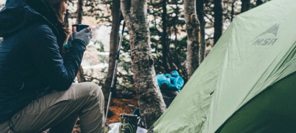 photo of woman and a tent with the caption: 6 reasons to go camping in the spring.