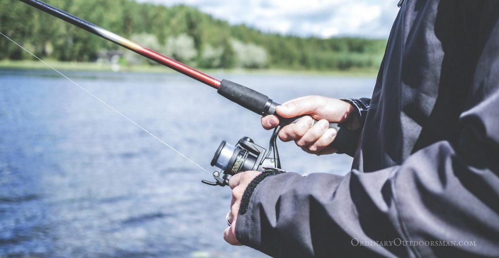 photo of man holding fishing pole - free fishing days in 2018