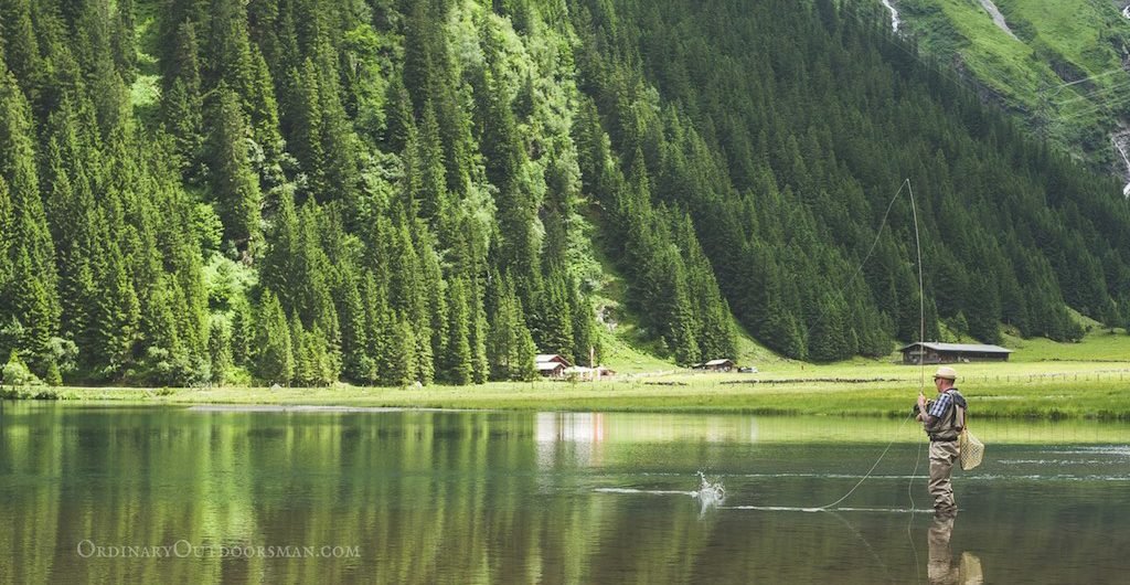 Man fly fishing on a mountain lake