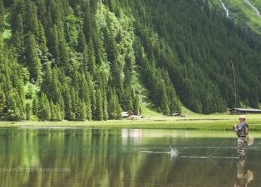 Man fly fishing on a mountain lake